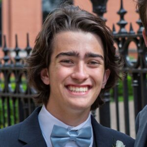 Smiling young man in suit and bow tie.