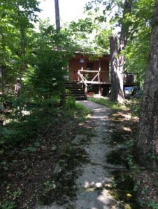 Path leading to a wooden cabin.