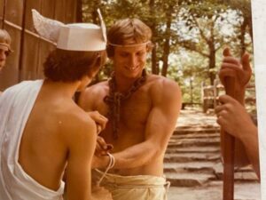 Two young men in a forest setting.