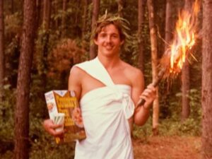 Man holding a torch and cereal box.