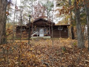 Autumn cabin in wooded area.