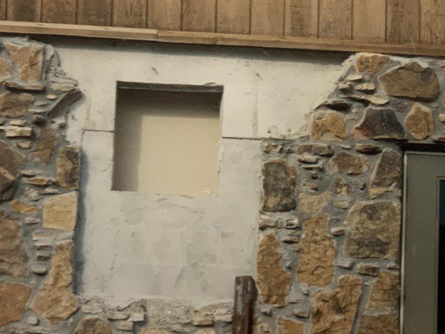 Stone wall with a window opening.