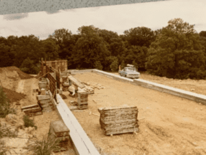 Construction site with a truck and wood.