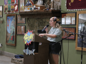 Woman speaking at a microphone at podium.