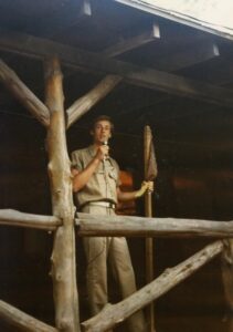 Man speaking into microphone on porch.