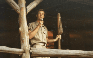 Young man giving speech on porch.