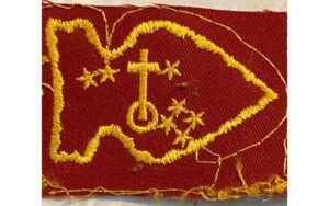Yellow embroidered design on red fabric.