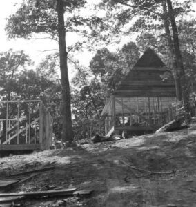 Black and white photo of cabin under construction.