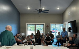 Priest leading a family Bible study.