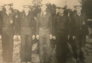 Black and white photo of six cowboys.