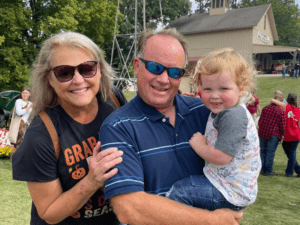A family portrait with a man holding a child.
