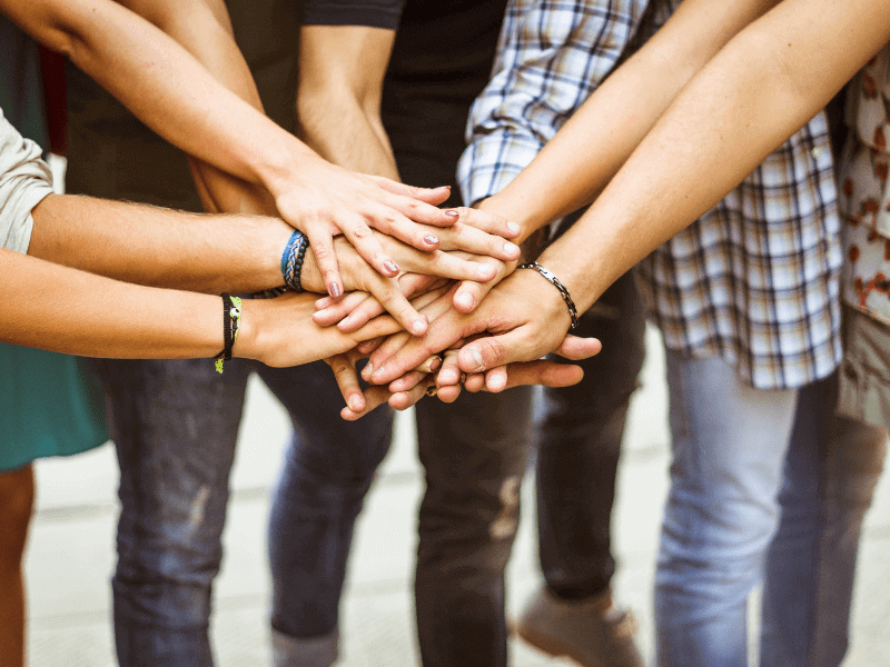 Group of friends with hands stacked together.