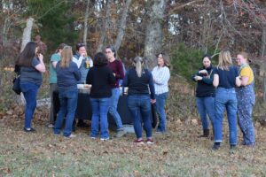Group of women in a wooded area.