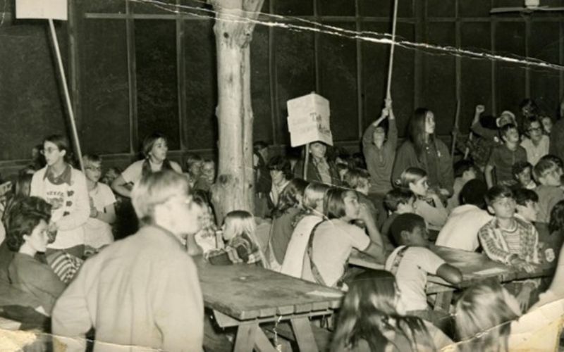 Children gathered in a large indoor setting.
