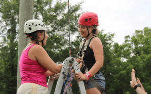 Two women preparing for a ropes course.