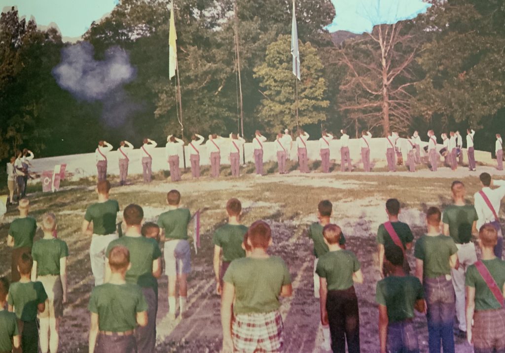 Boy Scouts saluting at a flag ceremony.