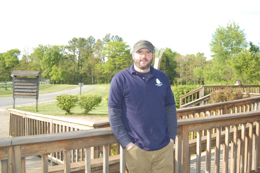 Bearded man standing on wooden deck