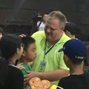 Man comforting children in a group.