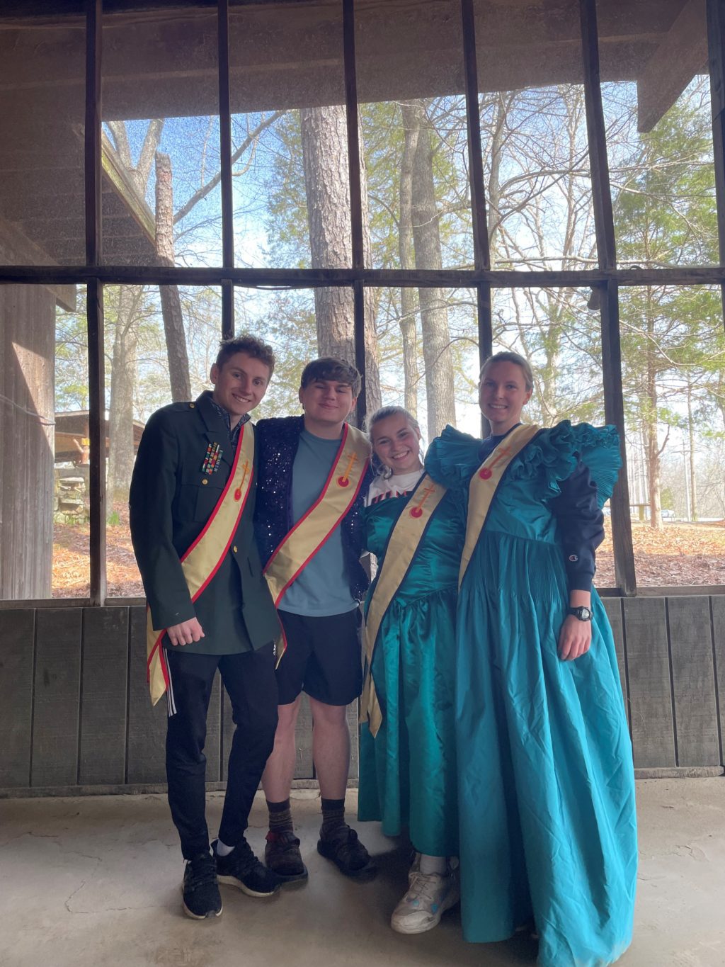 A group of people in costumes, gathered for the Spring Lodge Reunion, posing for a picture.